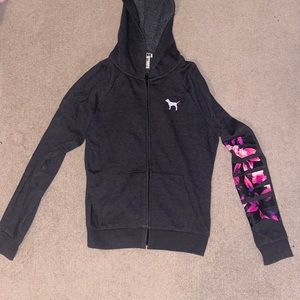 Grey hoodie with PINK logo on sleeve in a floral print.
